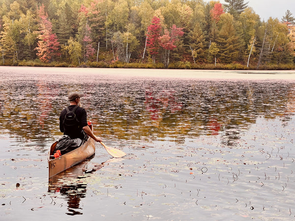 The author in his kevlar canoe, surrounded by fall color and lily pads.