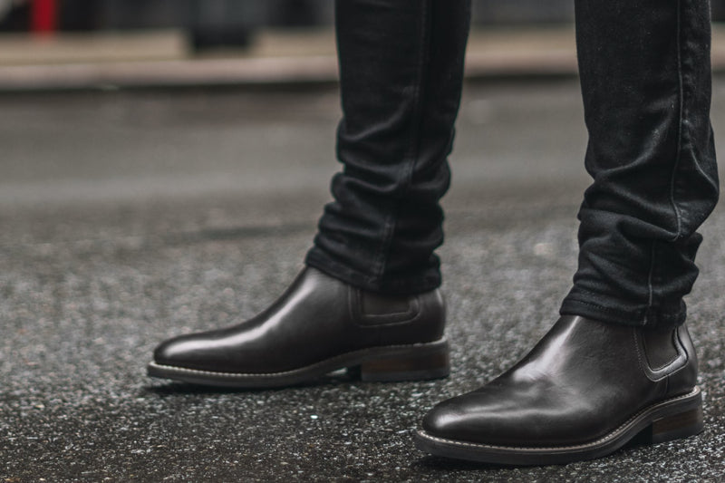 black chelsea boots on feet