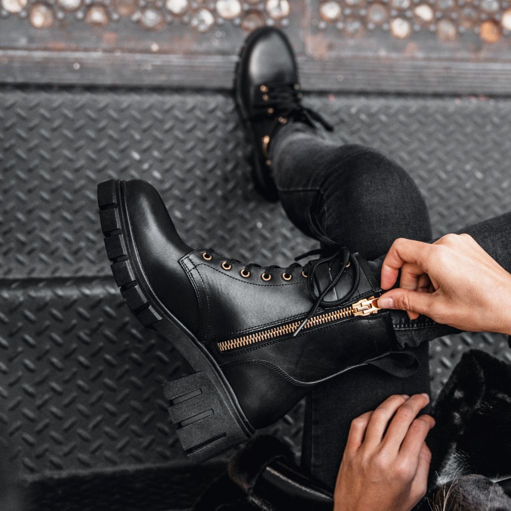 black combat boots with gold hardware