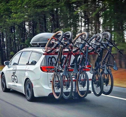 minivan driving with vertical hitch bike rack