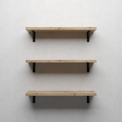 A triple stack of wooden shelves with black brackets