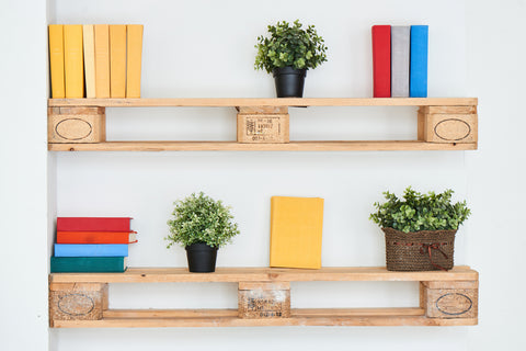 Two shelves made from wooden pallet sections decorated with coloured books