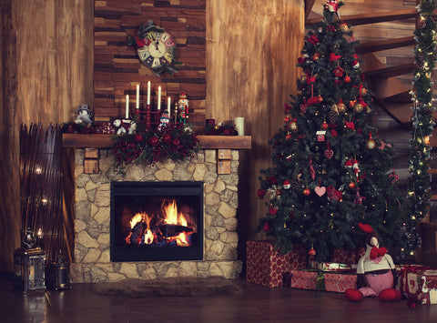 Christmas candles on top of mantel with lightly decorated Christmas tree off centred 