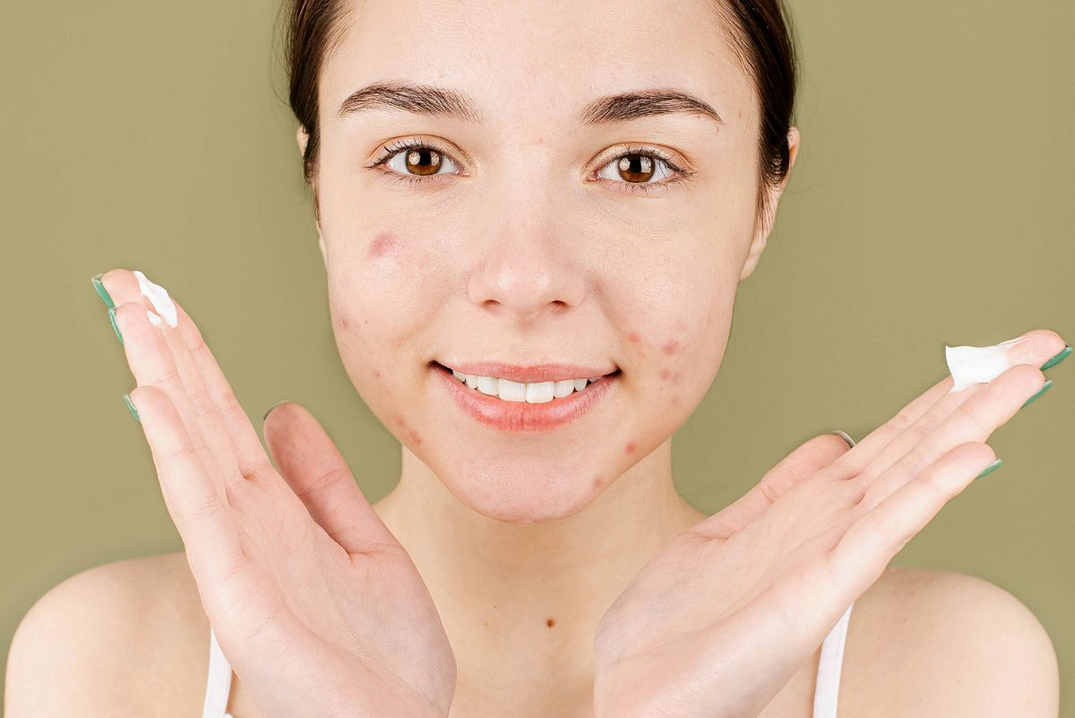 close up of woman holding hands up to her face