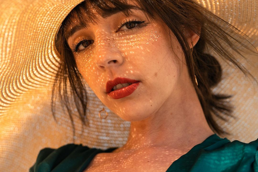 close up of a woman wearing a sun hat