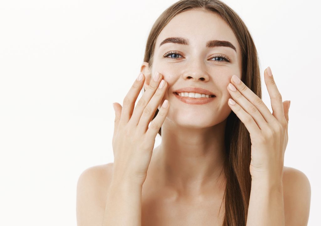 lady applying cream to her face