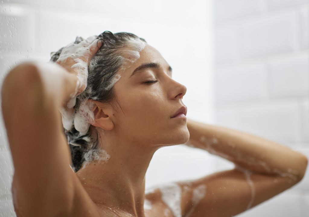 Lady washing her hair with CENTRED shampoo