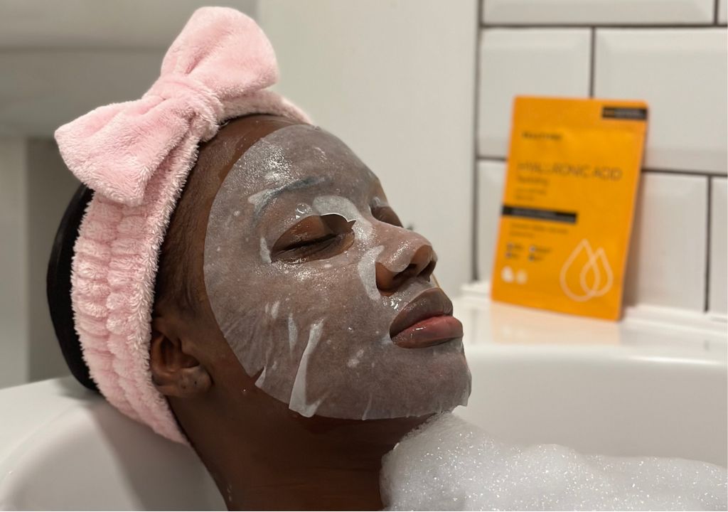 lady relaxing in a bath wearing a BEUATYPRO sheet mask