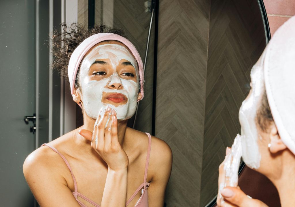 Person cleansing her face in the mirror