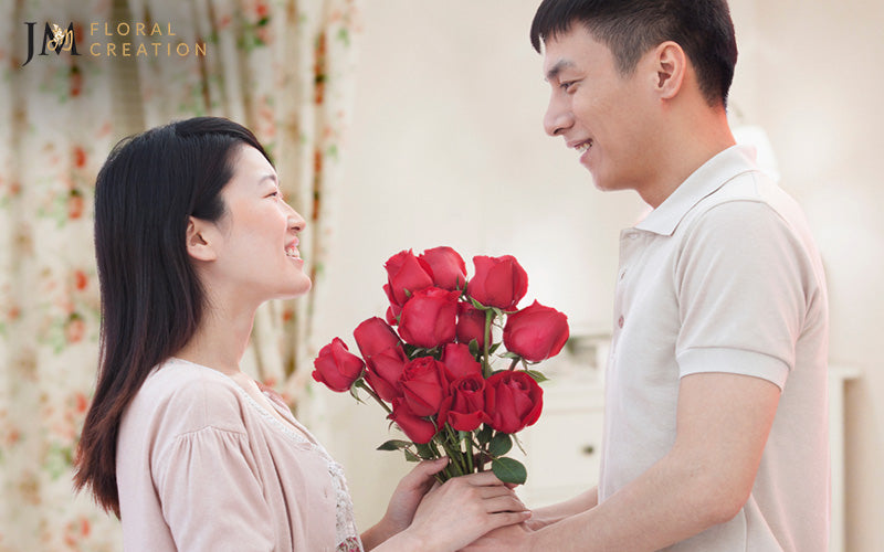 Image of a man giving red rose bouquet to a woman