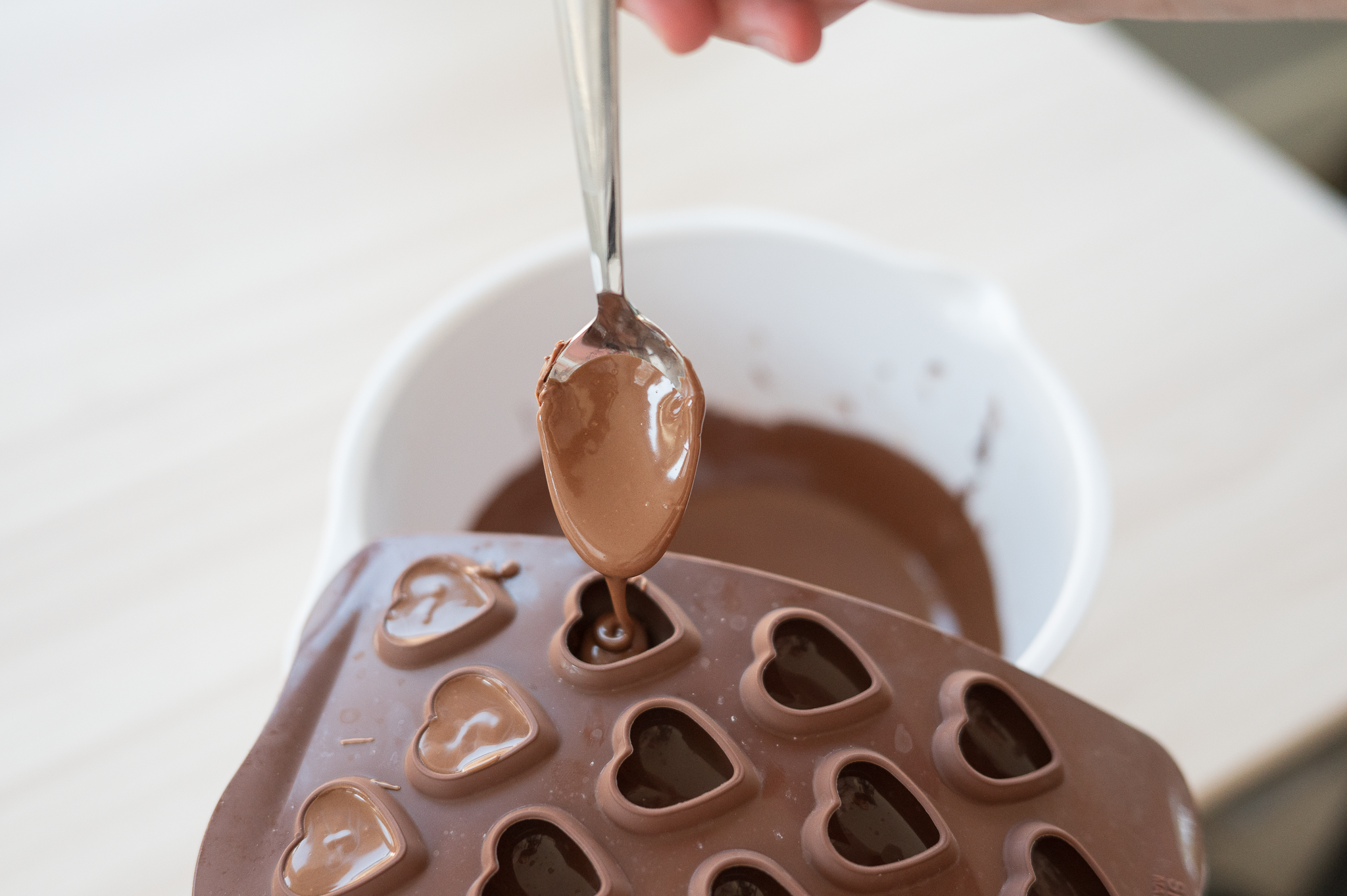 Dropping chocolate into mold