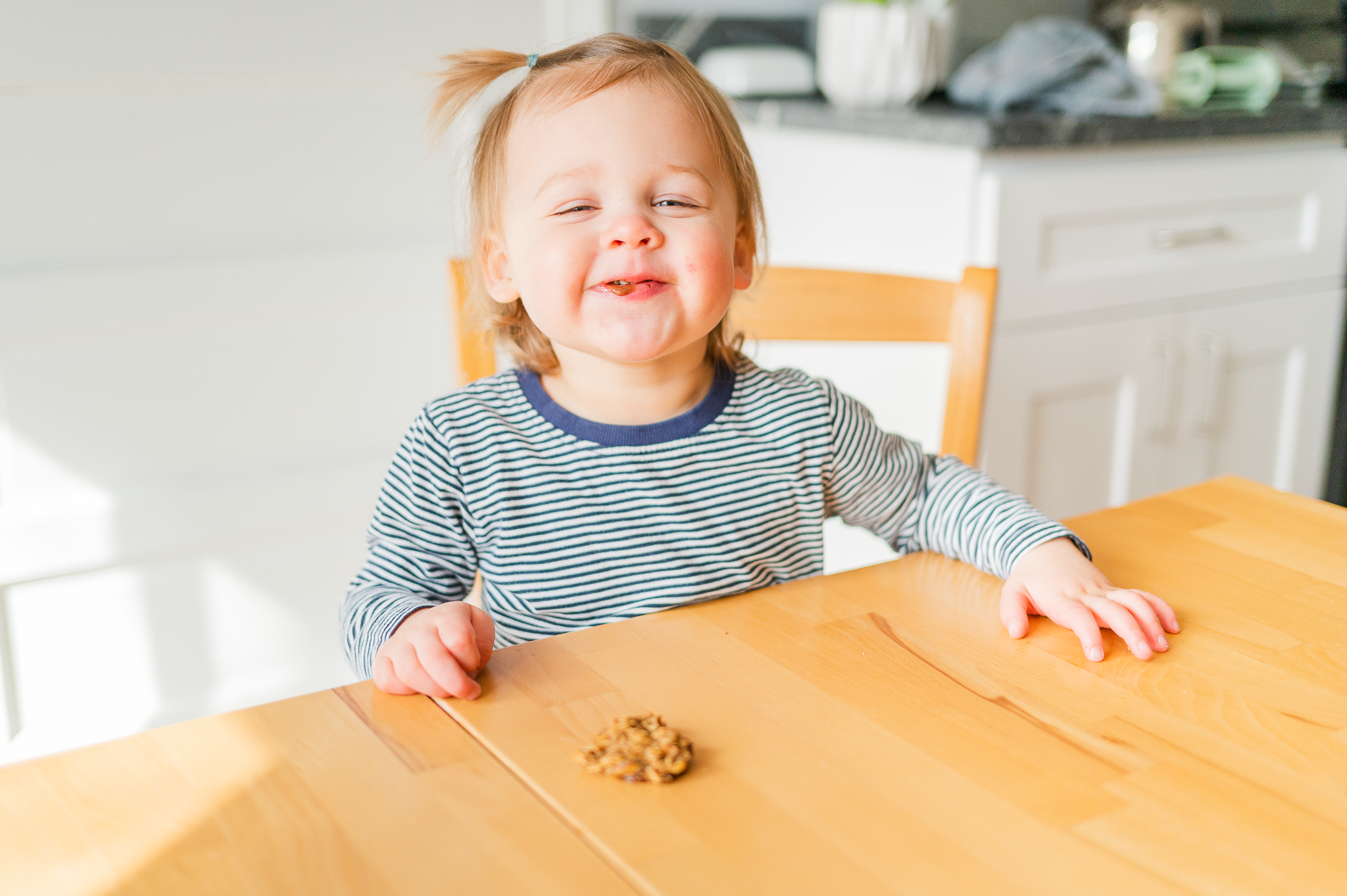 Nellie smiling eating a breakfast cookie