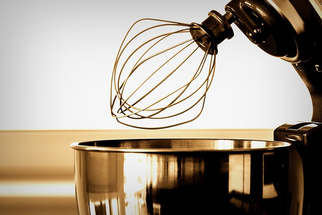 Mixer whisk over saucepan