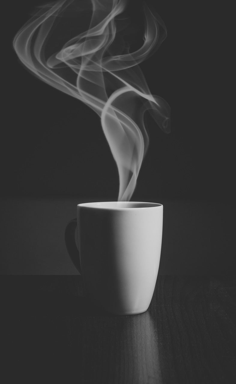White mug with steam coming out of it