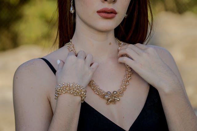 Woman wearing golden necklace and bracelet