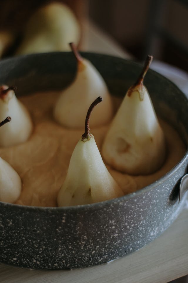 Dough and whole pears in baking dish