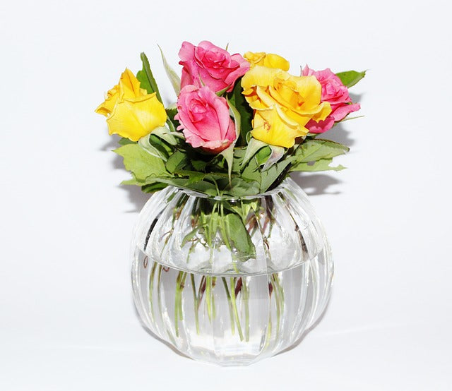 Bouquet of pink and yellow roses in a vase