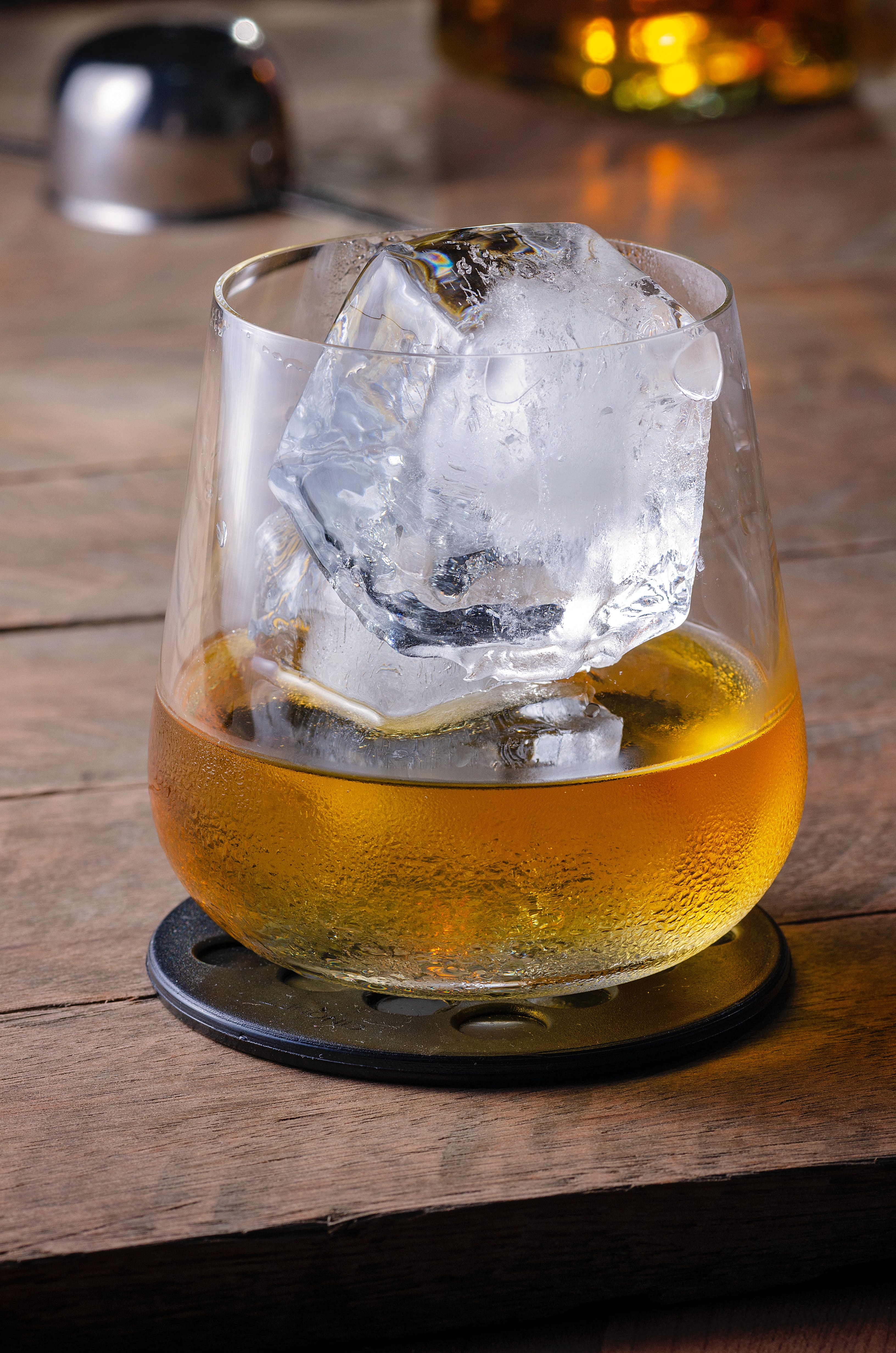 Cognac glass with drink and ice