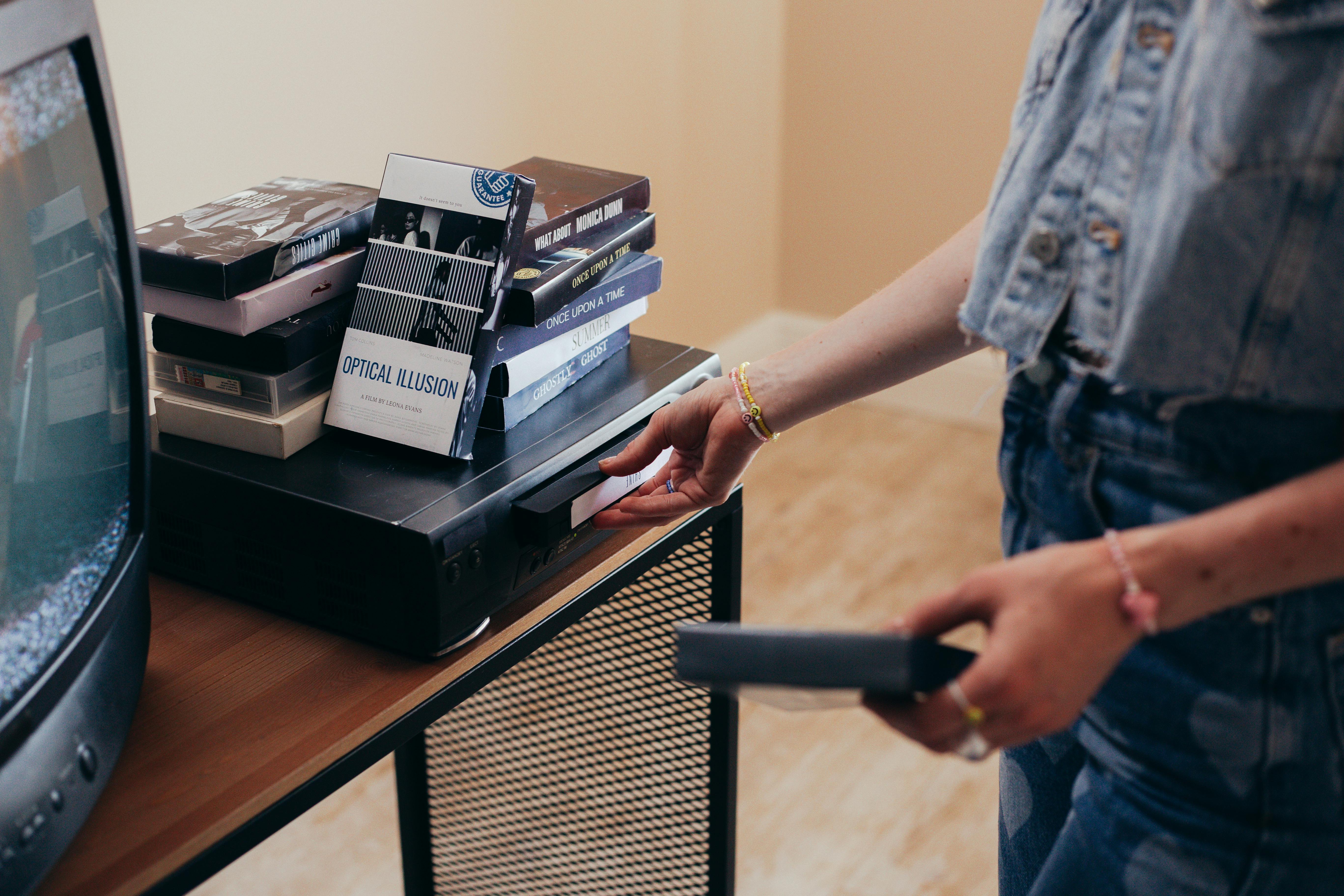 Videotapes on the table near the TV