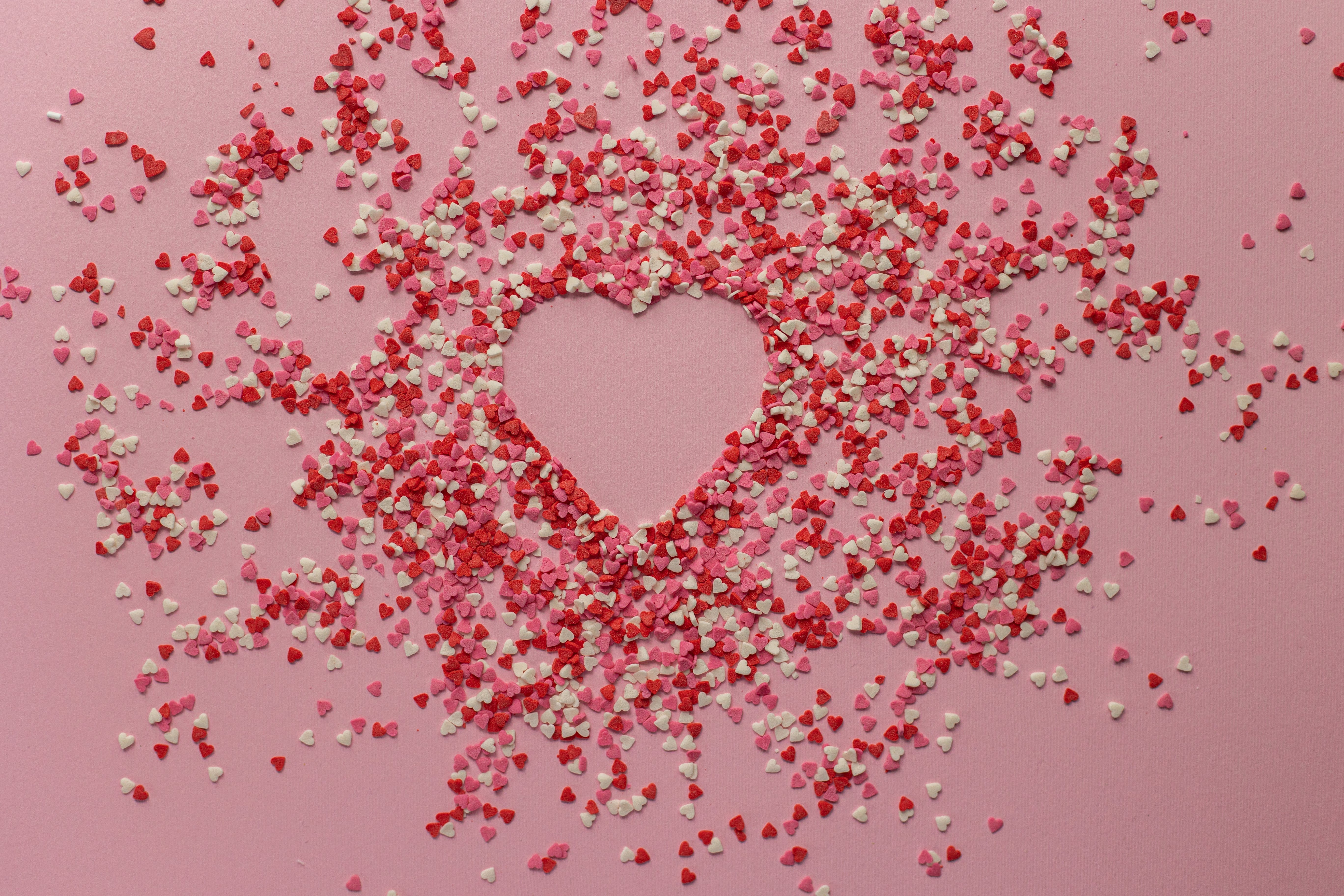 Candies in the shape of small hearts form a big heart