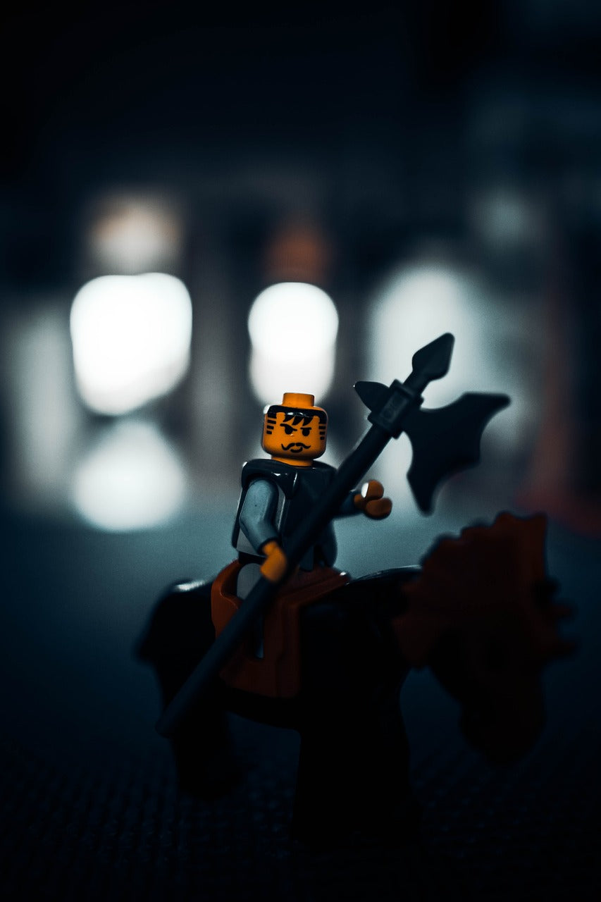 Lego figurine with an ax on a dark background