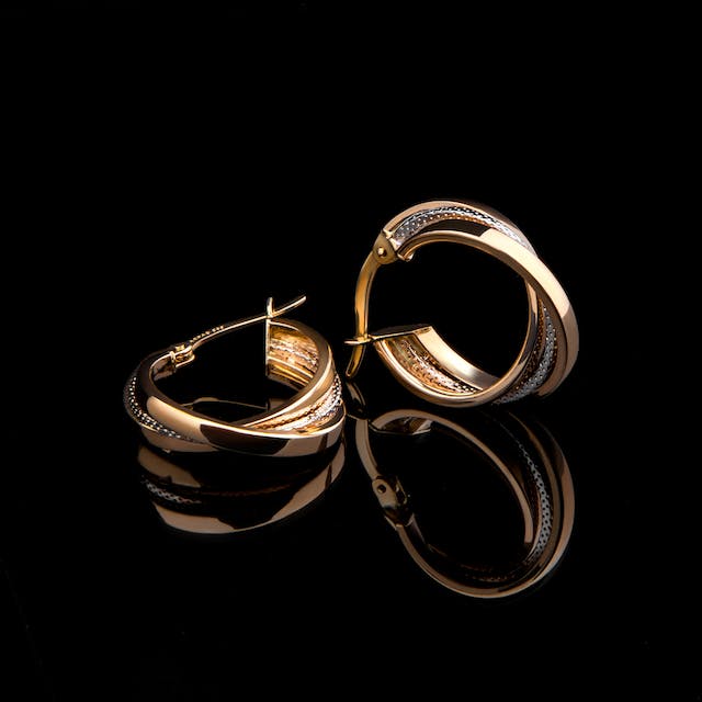 Gold earrings on a black background