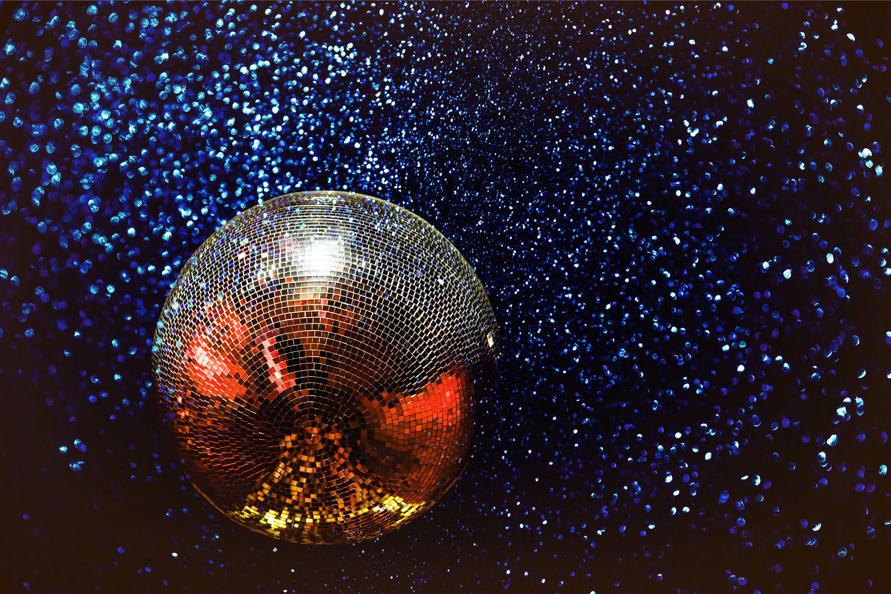 Disco ball on a dark background with light dots
