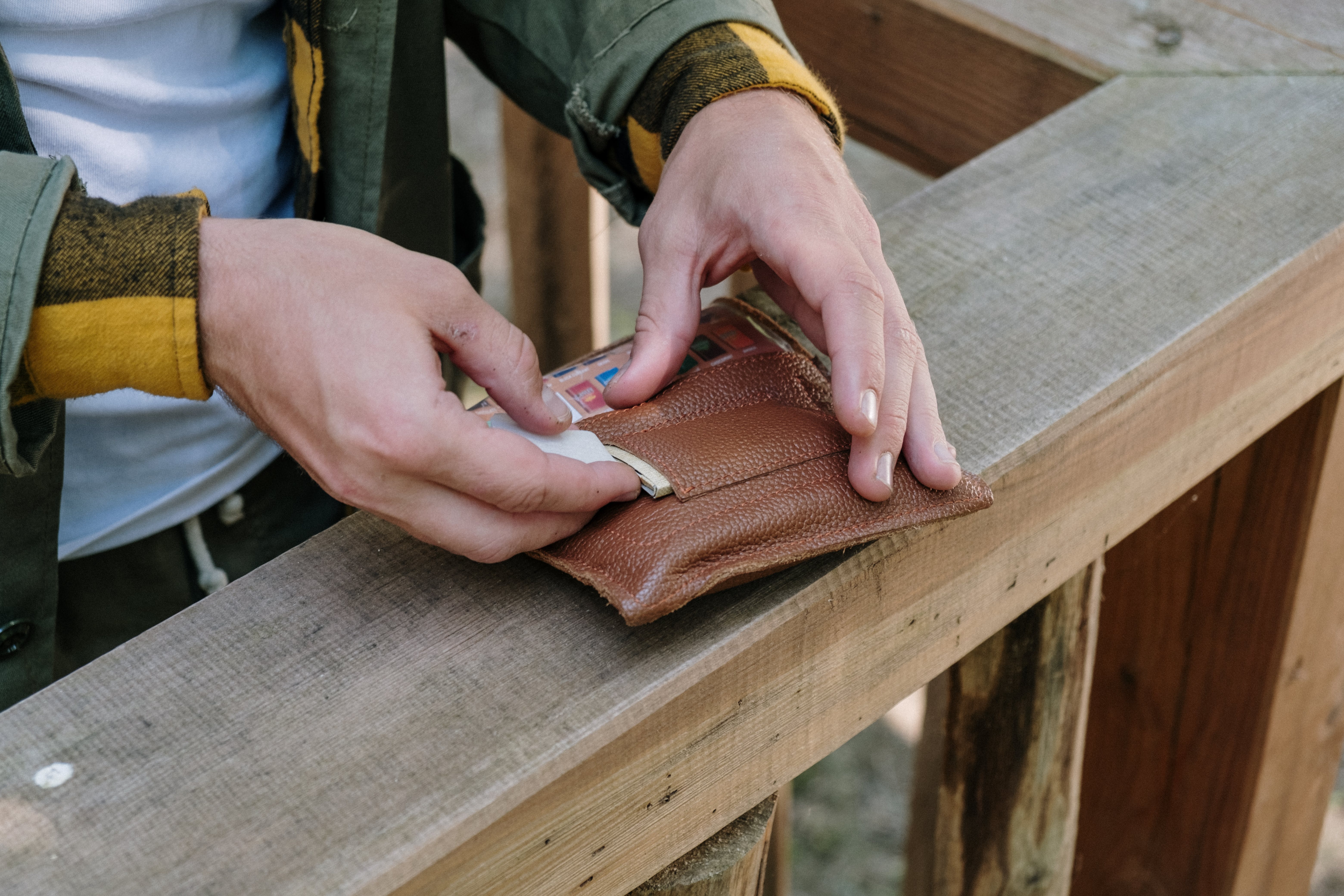 Man putting money in wallet