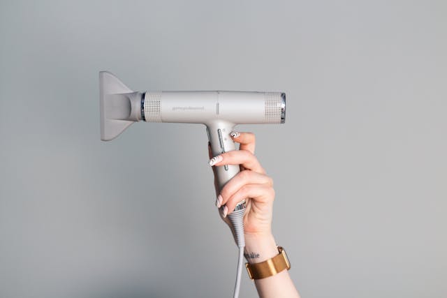 Female hand with hairdryer