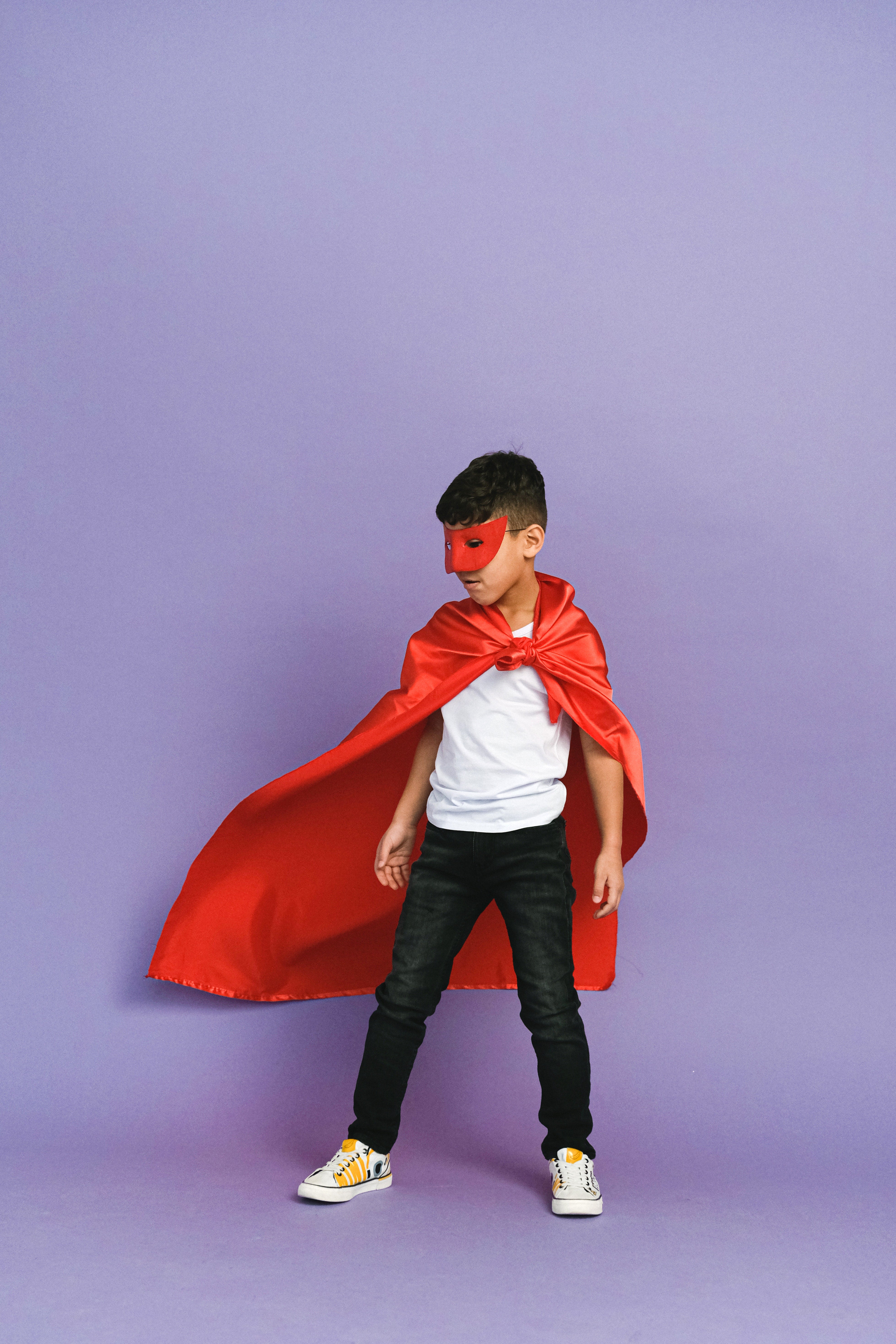 Boy in a red cloak and red mask