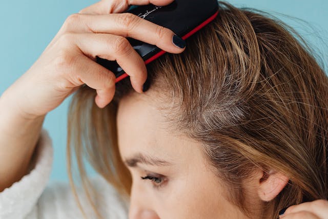  Woman combing her hair