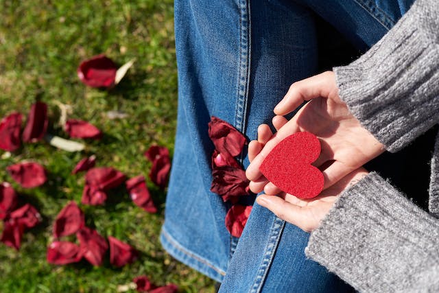 Red heart on two palms