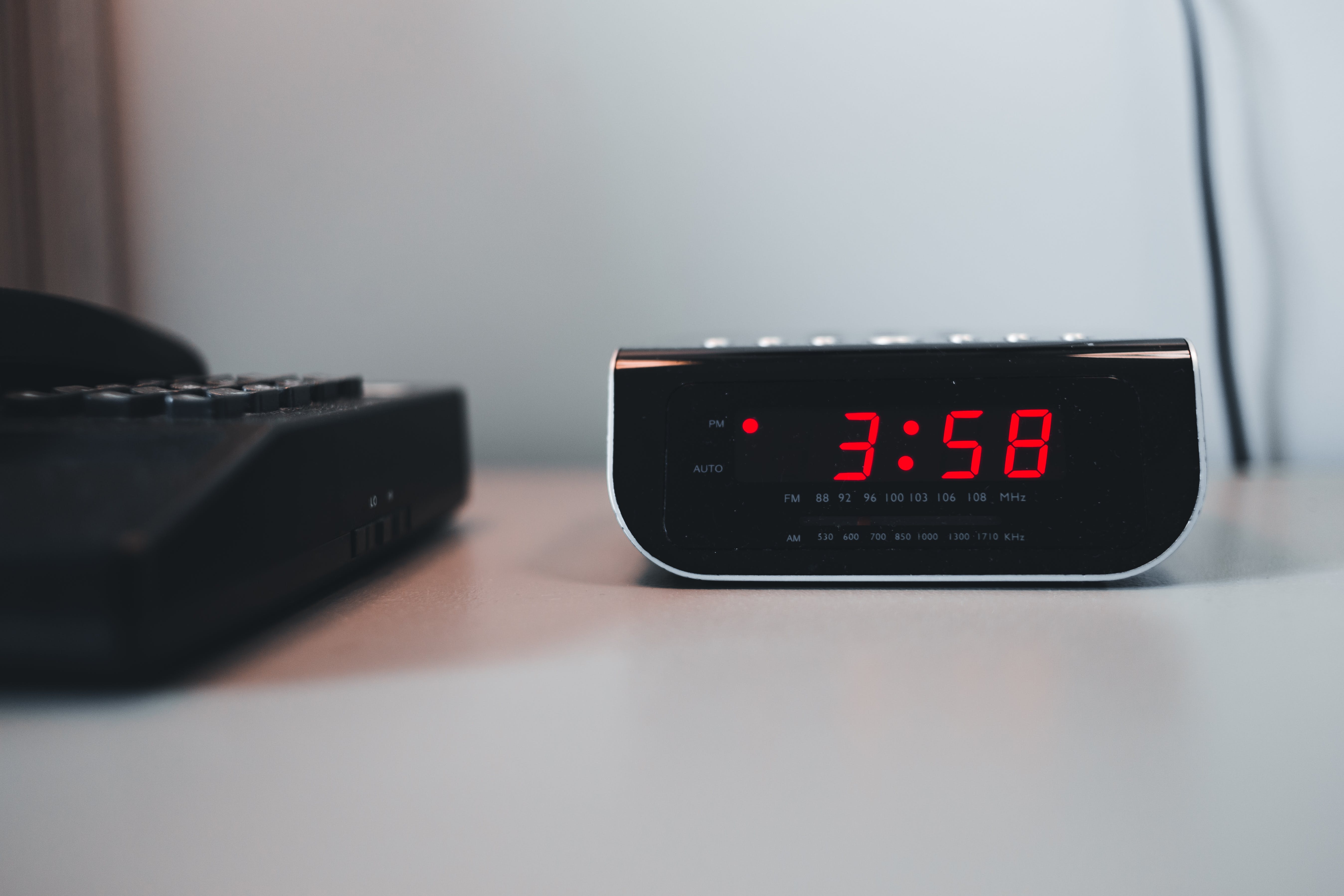 Black alarm clock with red numbers
