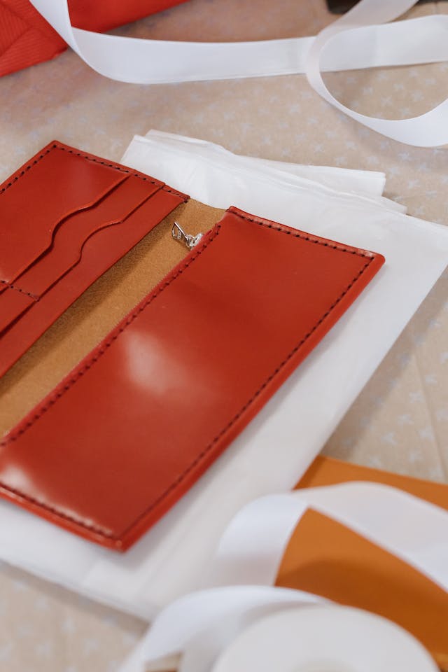 A red open wallet lies on a white napkin