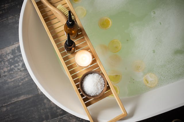Wooden tray on the edge of the bathtub