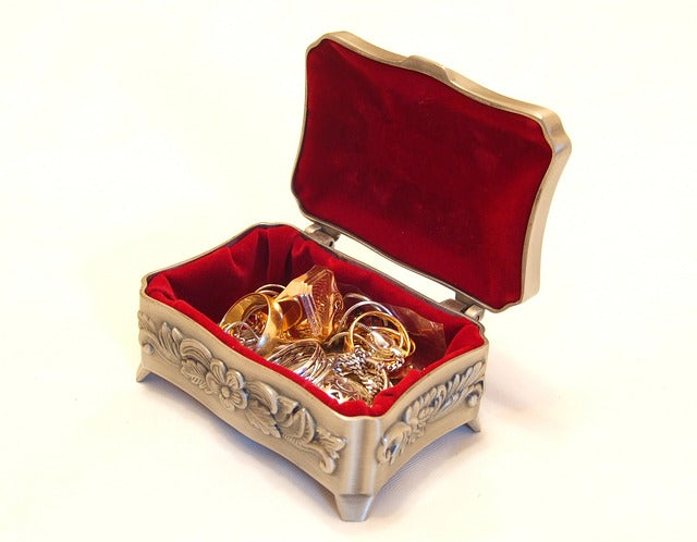 Open carved box with jewelry inside
