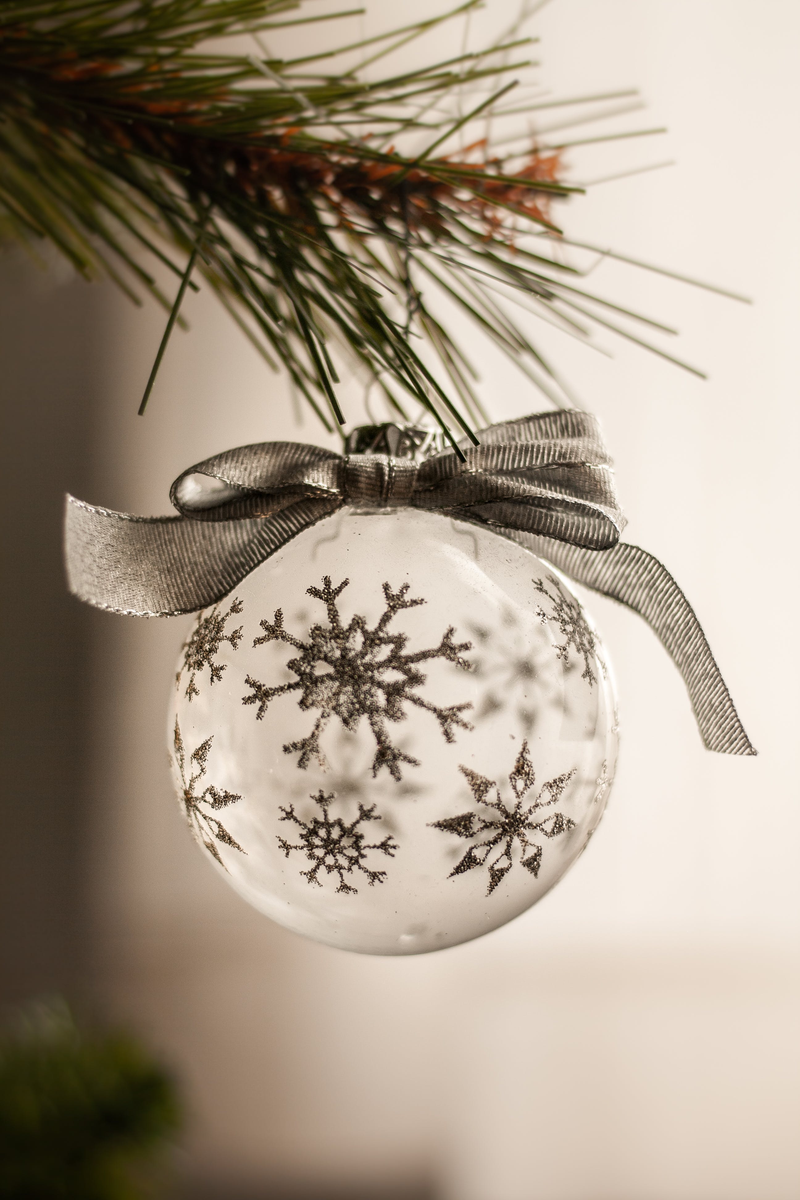White ball with snowflake print on the Christmas tree