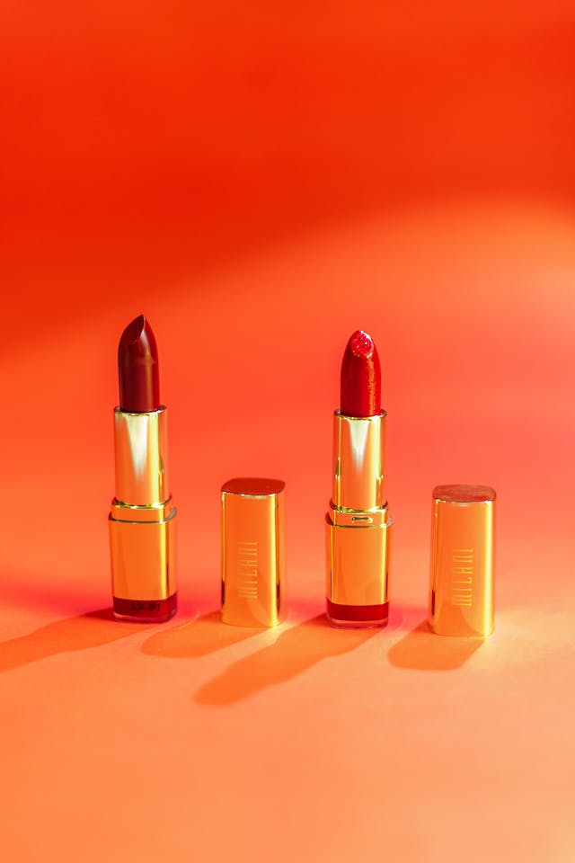 Two lipsticks in an orange background