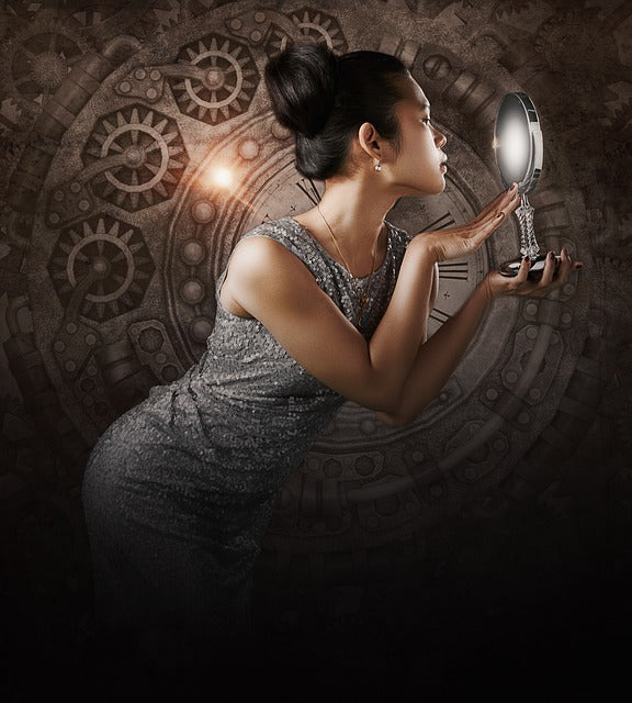 Woman looking into a round mirror