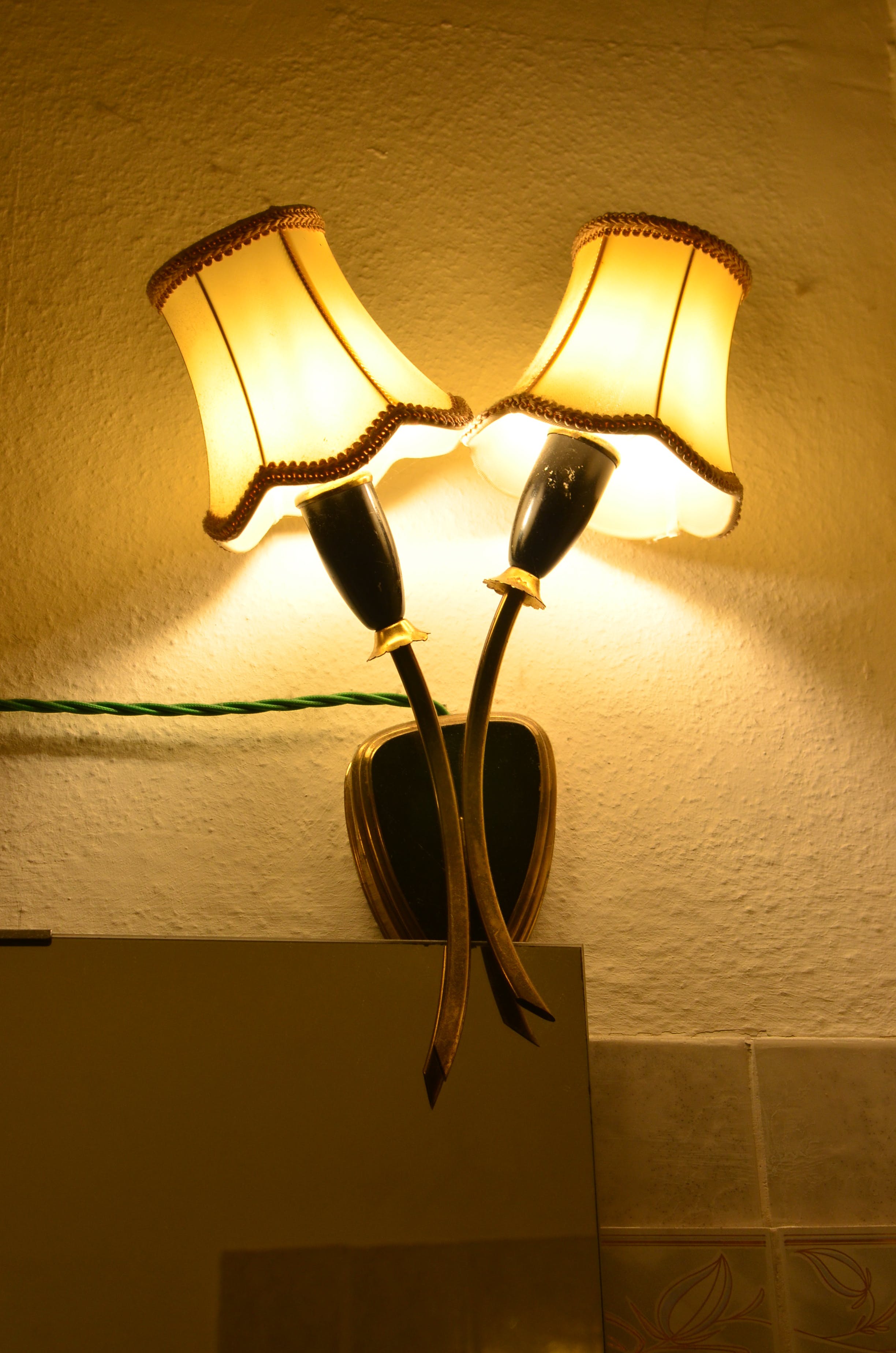 Switched on lamp near the wall