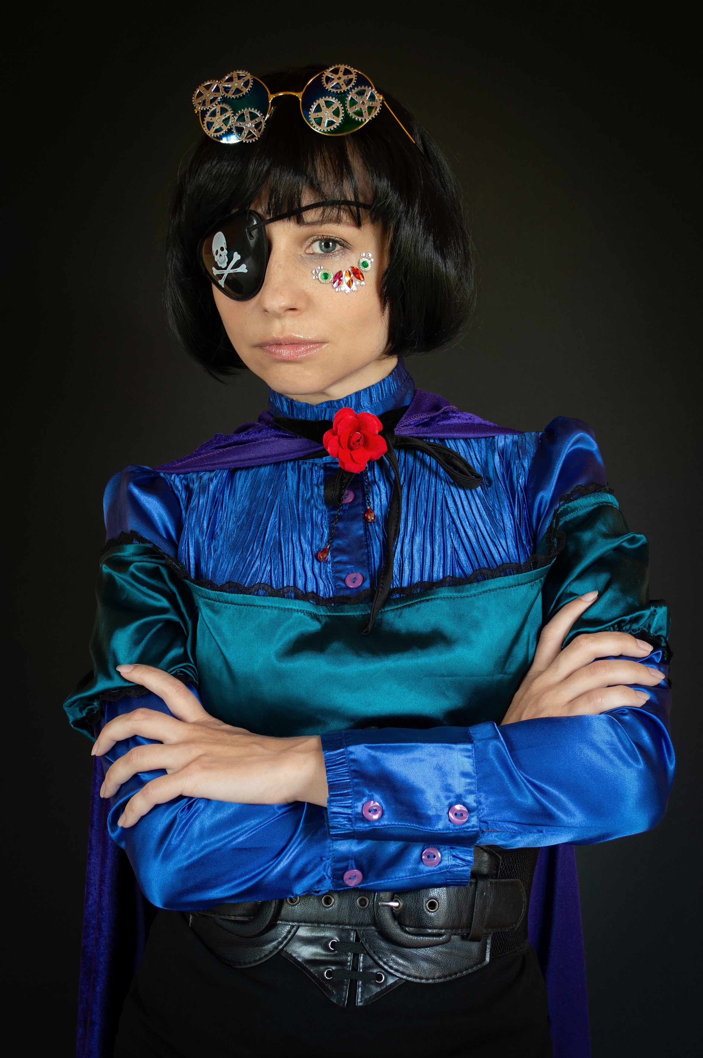 Girl in a pirate costume and with steampunk glasses on her head