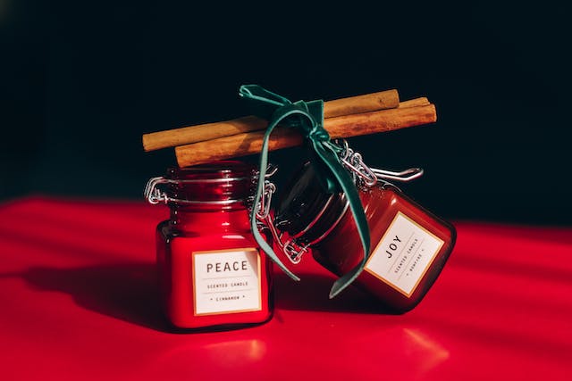 Cinnamon sticks lie on jars with candles
