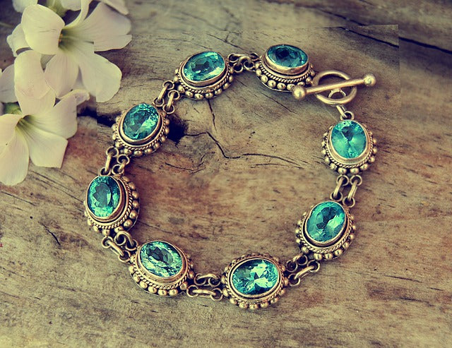 Bracelet with precious stones on a wooden surface