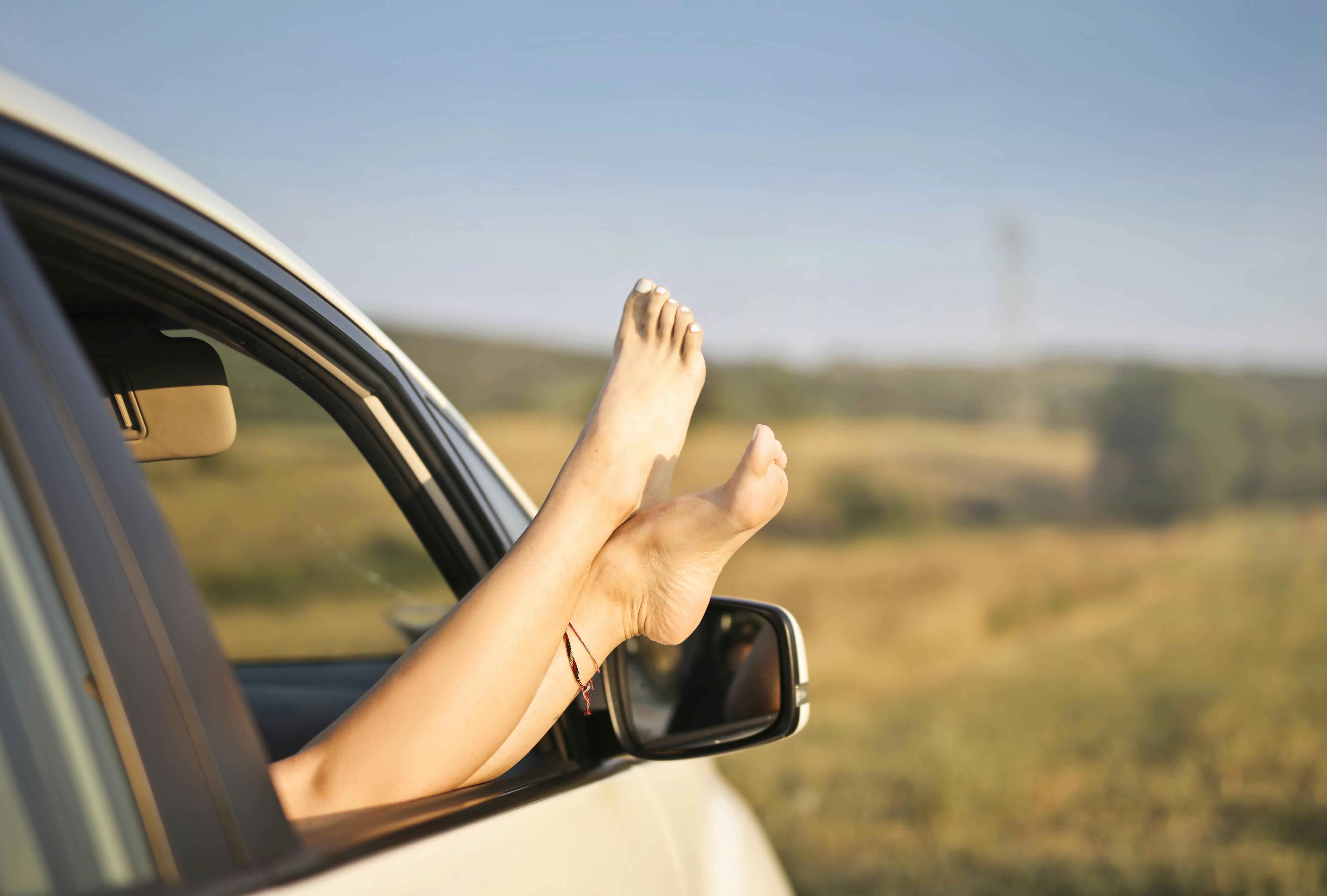 Woman's legs sticking out of a car window