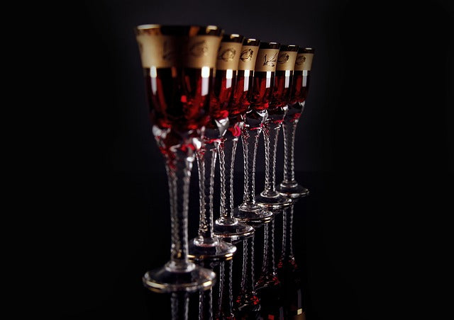 Row of wine glasses on black background