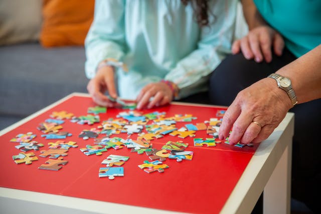 Elderly couple putting together puzzles