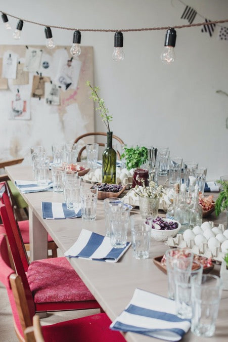 Served table and a garland of light bulbs above it