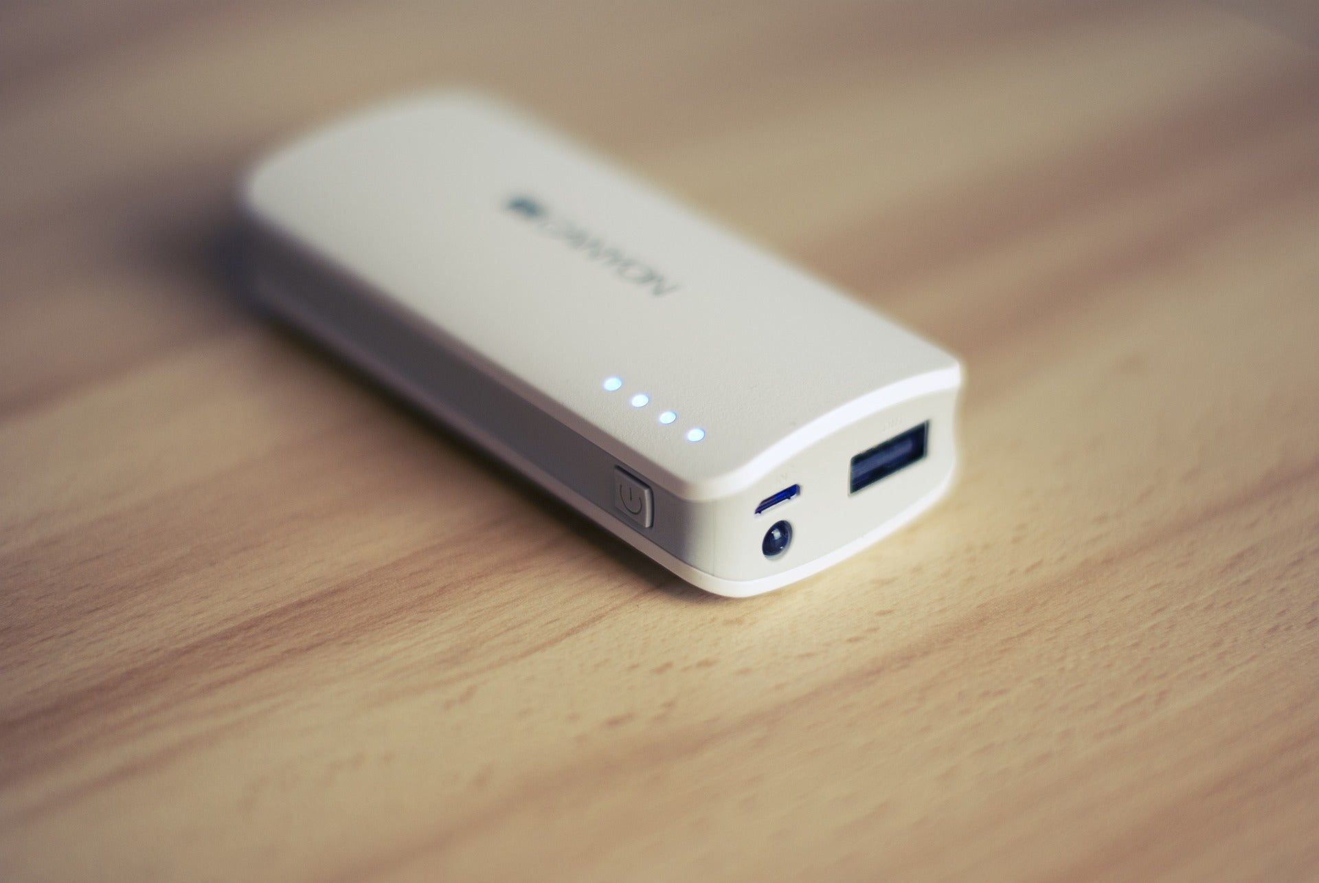 White power bank on a wooden surface