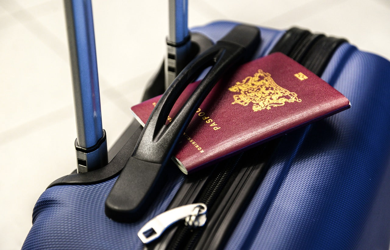 Passport under the handle of the suitcase