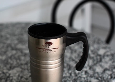 Thermal mug stands on a gray table